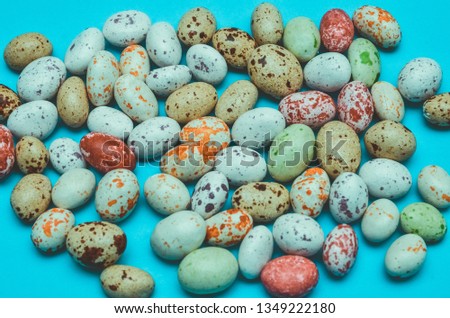 Eastern sweets. Peanuts in colorful icing sugar on a blue background.