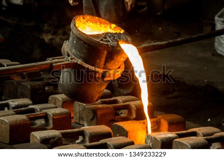 metal casting process with red high temperature fire in metal part factory