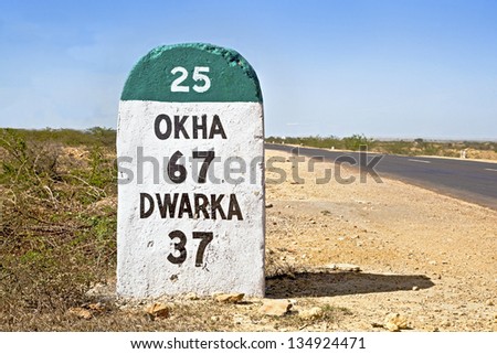 Gujarat India, the 37 kilometers Milestone to Dwarka on the state highway 25 which runs through some of the most barren parts of the country in Gujarat, India Royalty-Free Stock Photo #134924471