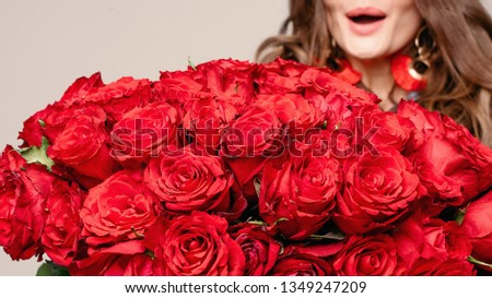 Amazed and happy brunette surprised with roses.