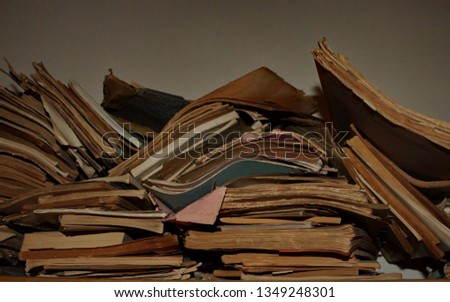 An end view of several books, magazines and pamphlets of various sizes, randomly stacked together. Royalty-Free Stock Photo #1349248301