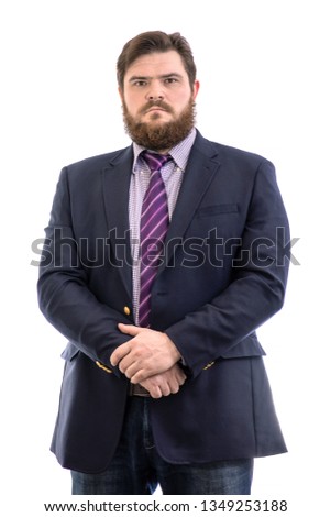 Portrait of a big handsome serious bearded business man in a dark suit and a bright blue tie, isolated on white background