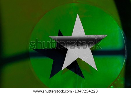 Gray steel five-pointed star on a green background