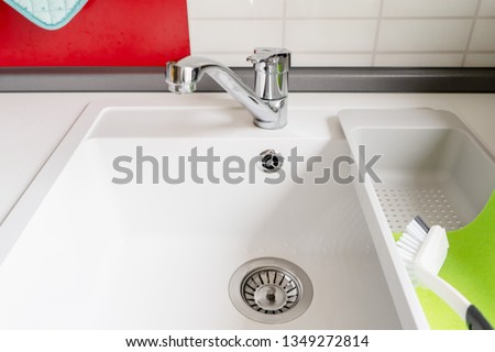 kitchen sink, cleaning brush and rag