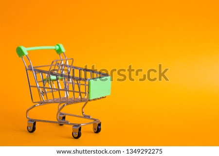 Empty shopping basket on orange background
