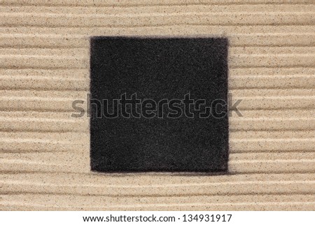 The black square on the sand can be used as background