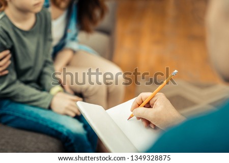 Professional notes. Selective focus of an open notebook being in use while taking the notes Royalty-Free Stock Photo #1349328875