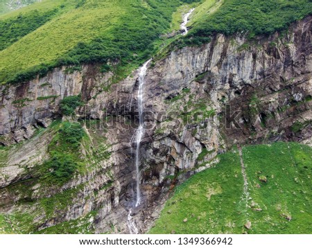 Waterfall Wannenbachfall in the alpine valley of Im Loch - Canton of Glarus, Switzerland