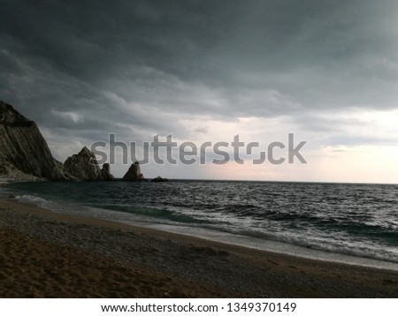 Picture taken just before the storm at the two sisters beach ( spiaggia delle due sorelle ) in the Conero area in Italy.
