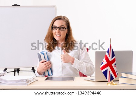 Female english language teacher in front of whiteboard