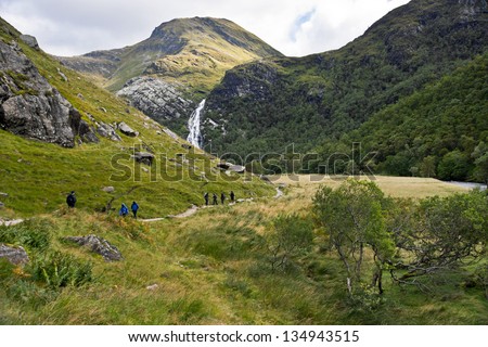 Steall Fall, Scotland, West Highlands (Ben Nevis, near Fort William): The spectacular 120m waterfall (aka An Steall Ban), seen in the distance from the path that runs through the Nevis Gorge. Royalty-Free Stock Photo #134943515