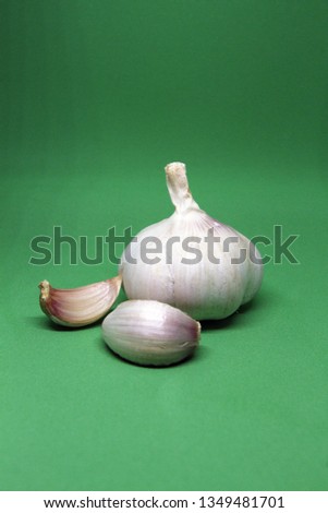 Close-up of garlic clove on green background