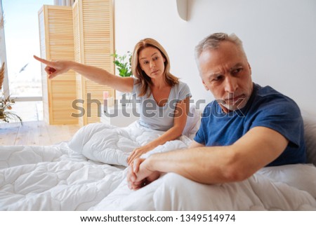 Categorical wife. Grey-haired husband not listening to his categorical emotional wife Royalty-Free Stock Photo #1349514974