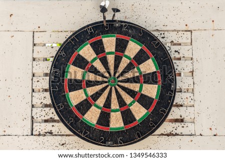Close up old target dartboard with wooden background.
