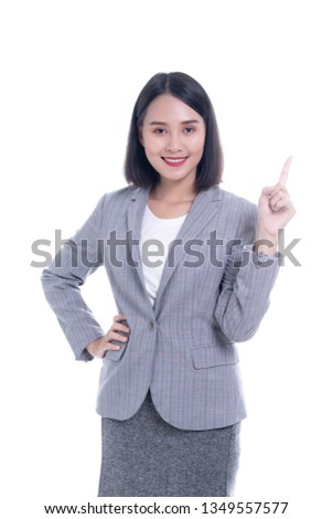 Happy cute smiling beautiful young Chinese Thai Asian Looking camera showing copy space pointing something she wearing a brown black suit, isolated over white background, - success concept