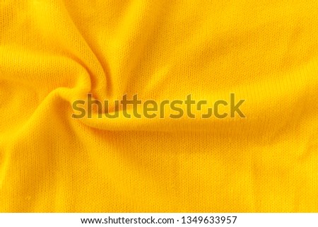 Yellow crocheted fabric texture.crumpled in a spiral