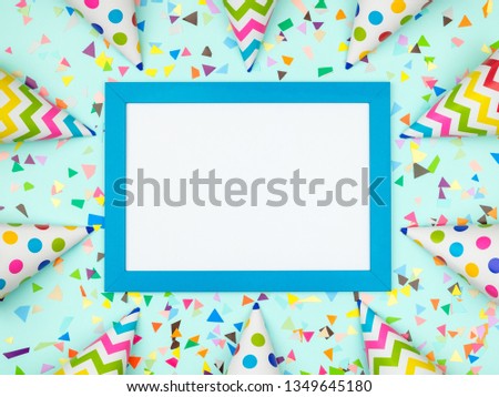 Blank card with different celebratory items on colorful background, top view