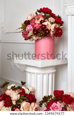 Big bouquet of flowers on the column. A large bouquet of flowers on a column in the lobby.