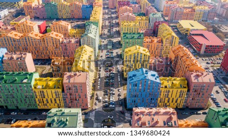 panoramic aerial view of colorful (red, green, blue, yellow) modern buildings on city street. drone shot