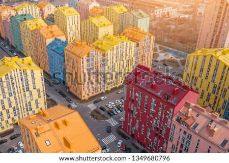 panoramic aerial view of colorful (red, green, blue, yellow) buildings on city street. drone shot