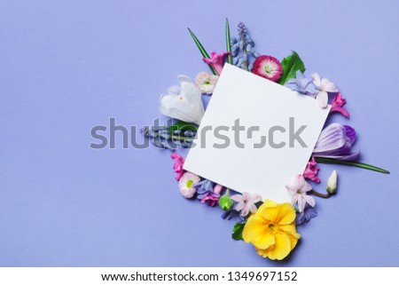 Flat lay composition with spring hyacinth flowers and blank card on color background, space for text