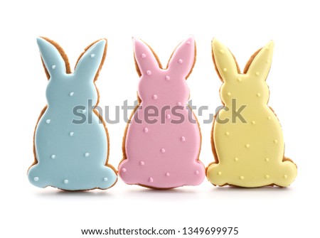 Tasty Easter cookies in shape of bunnies on white background