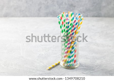 Colorful paper straws for cocktail in a glass.