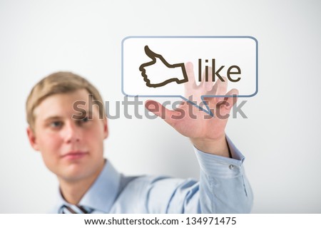 Business man touching social media button with thumb up symbol on a virtual screen