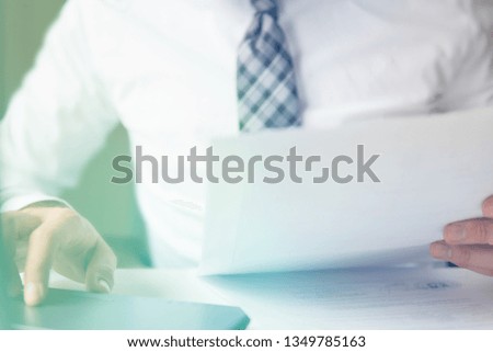 Businessman work with computer on table in office work. Light background. Smartphone in hand Young bearded businessman. Financial business. Office work with a laptop. Close up.
