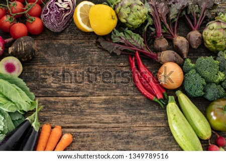 Many vegetables on the rustic table.