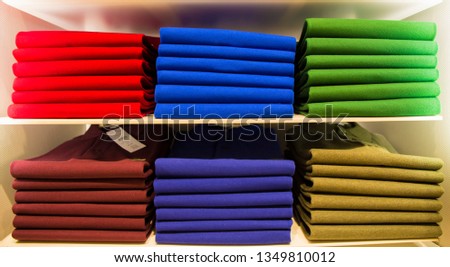 Column of clothes arranged on the shelf Royalty-Free Stock Photo #1349810012
