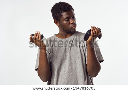 Man of African appearance with gamepads in his hands from a video game gaming console