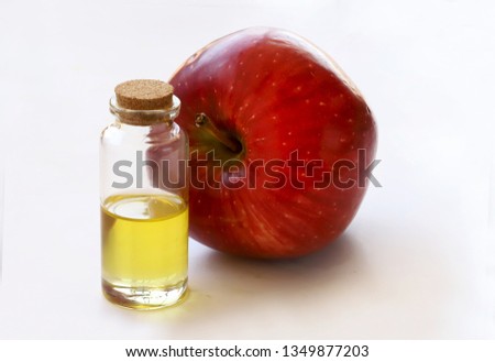 Apple and apple oil on a white background
