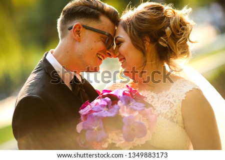 Beautiful wedding couple posing in park