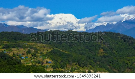 Panoramic view of Makalu mountain in the background, rice fields and forests in the foreground, Nepal