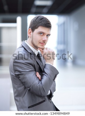modern successful businessman on background of office