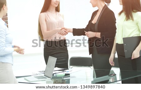 handshake of Manager and client in office room
