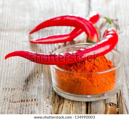 Red peppers on wooden table Royalty-Free Stock Photo #134990003