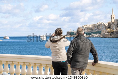 Tourists on the beach visiting the sights of Malta