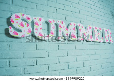 Summer room decor. Three-dimensional letters of foam on a brick wall. Watermelon print in the interior. Decorative letters for decoration.