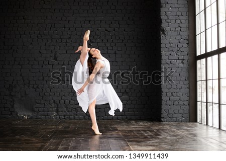 Girl gymnast, performs various gymnastic and fitness exercises. The concept of childhood and sport, a healthy lifestyle.