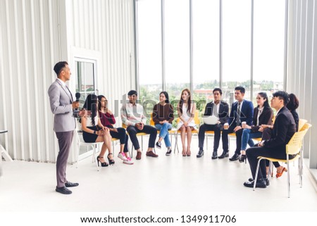 Businessman standing in front of group of people in consulting meeting conference seminar at hall or seminar room.presentation and coaching concept Royalty-Free Stock Photo #1349911706