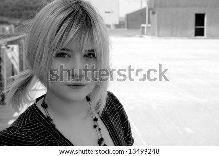 Lovely Girl on a rooftop with a pony-tail, intense look black and white photo