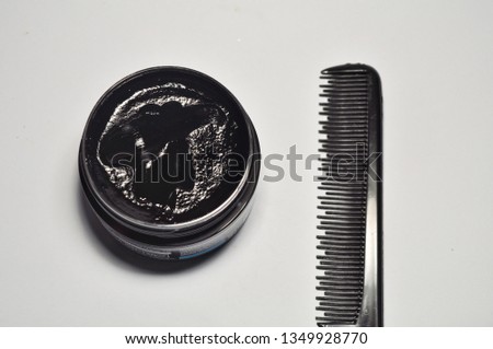 comb and pomade on white background