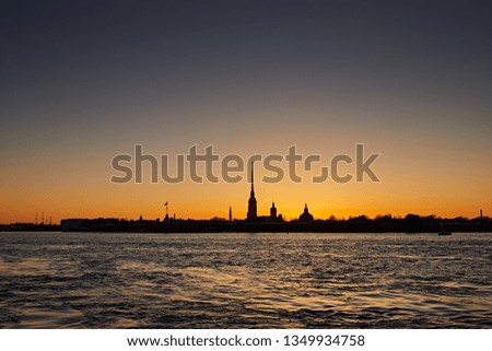 Peter and Paul Fortress on the Neva River against the sunset sky. Silhouette of the sights building