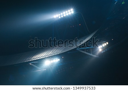 Stadium lights against dark night sky background. Soccer match lights. Royalty-Free Stock Photo #1349937533