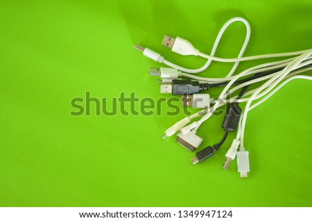 Phone charging cable placed on a green background