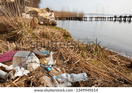 Garbage left by a river bank, environment pollution problem concept picture.