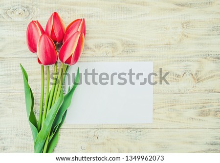 congratulations and tulips on a light background. selective focus. nature.