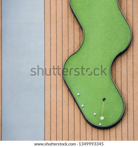 Abstract and conceptual image of a miniature golf game on a cruise ship